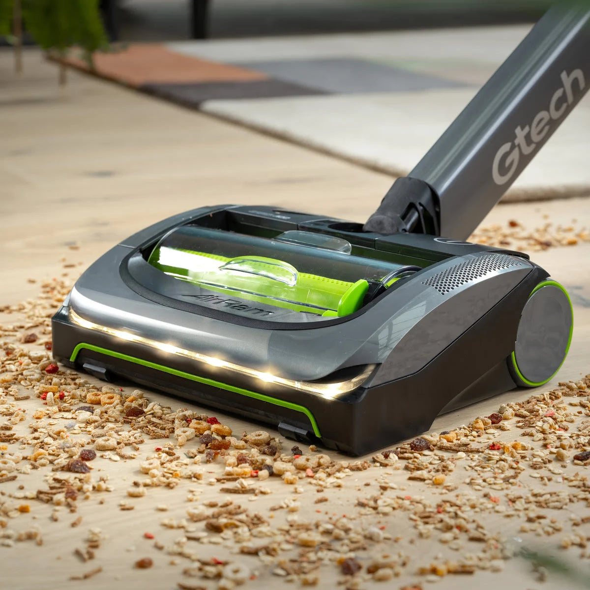 Gtech AirRAM 2 cordless vacuum cleaner cleaning a cereal off wooden floor
