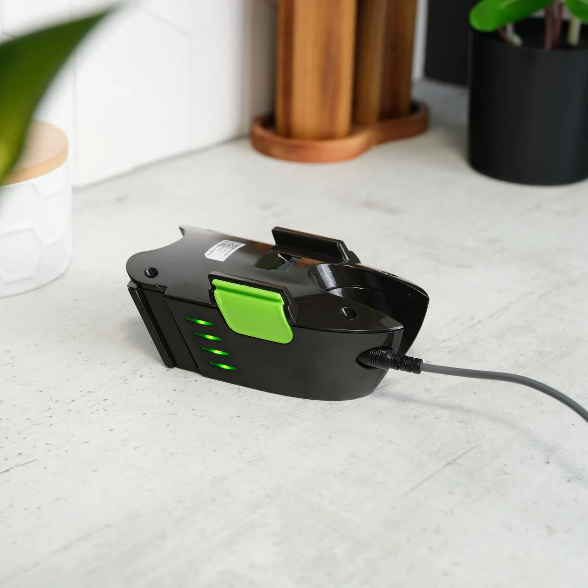 Multi handheld vacuum battery charging on counter top.