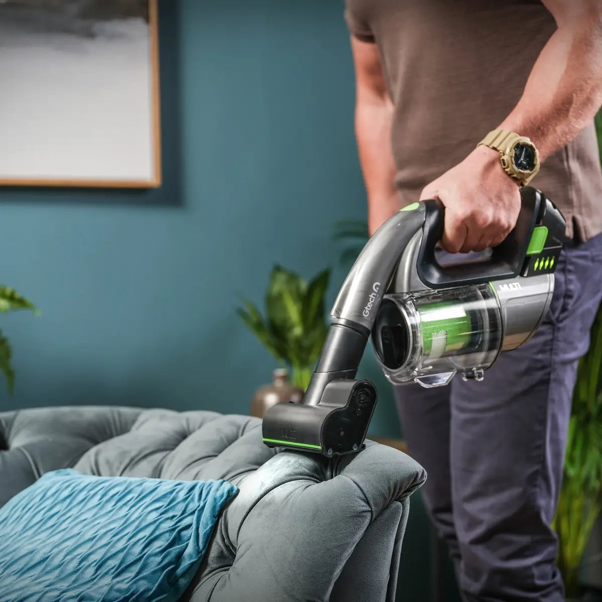 Close up of Multi 2 cordless vacuum power brush head vacuuming edge of the sofa.