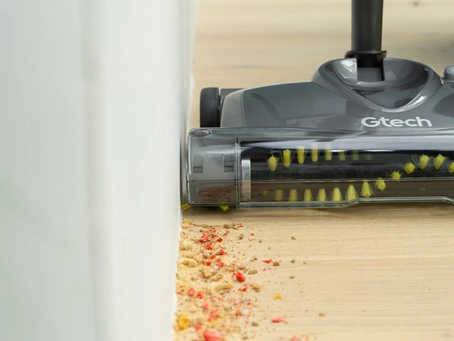 Gtech SW22 carpet sweeper edge brushes picking up dirt from skirting board.