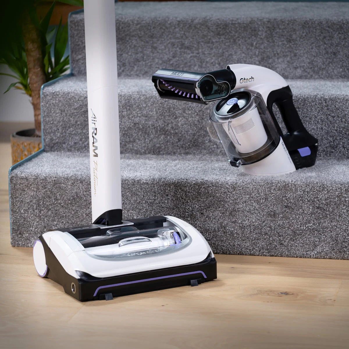 System Platinum vacuum bundle with AirRAM Platinum upright cordless vacuum and Multi Platinum handheld cordless vacuum resting on bottom of carpeted stairs.